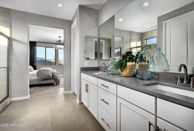 full bath with baseboards, plenty of natural light, recessed lighting, and double vanity