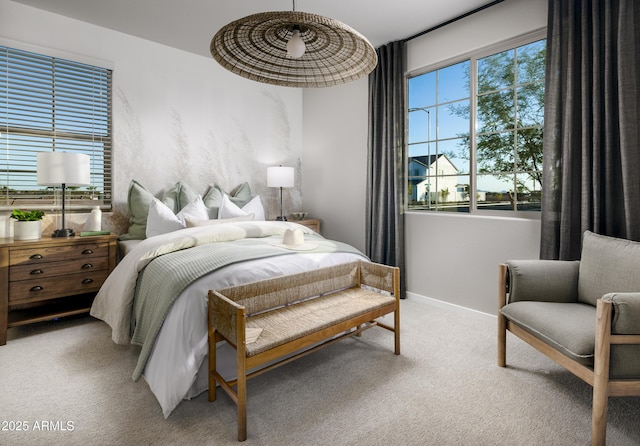 bedroom featuring light carpet and baseboards