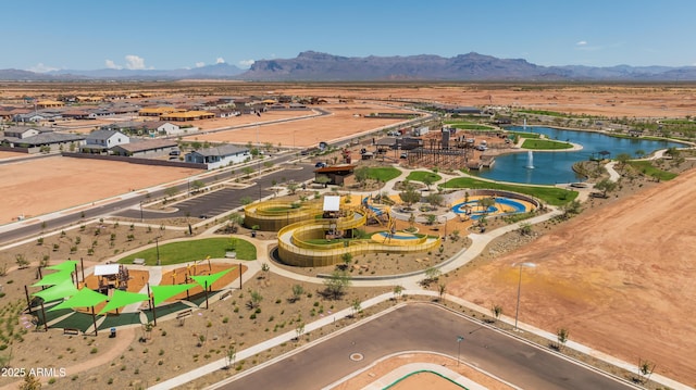 aerial overview of property's location with a water and mountain view and nearby suburban area