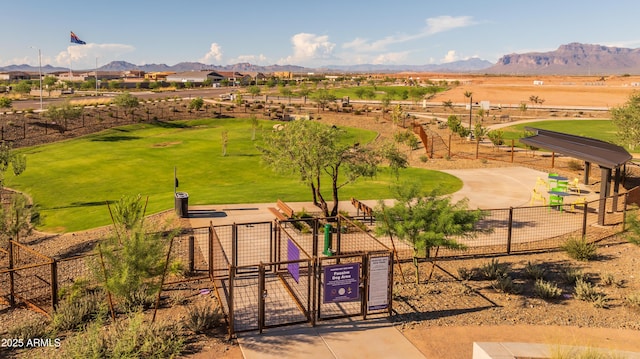 view of property's community featuring fence, a gate, and a mountain view