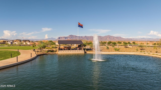 view of swimming pool with a water and mountain view