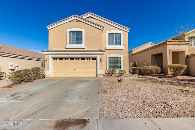 traditional-style home featuring driveway, a tiled roof, an attached garage, and stucco siding