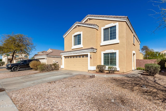 traditional home featuring a tile roof, stucco siding, an attached garage, fence, and driveway