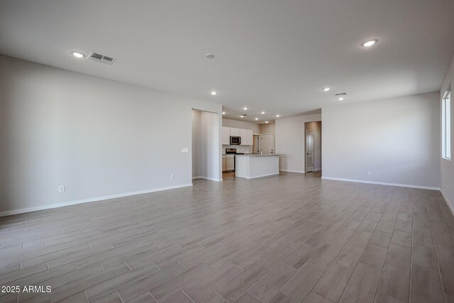 unfurnished living room featuring light wood-type flooring