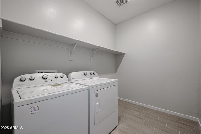 clothes washing area with washing machine and dryer