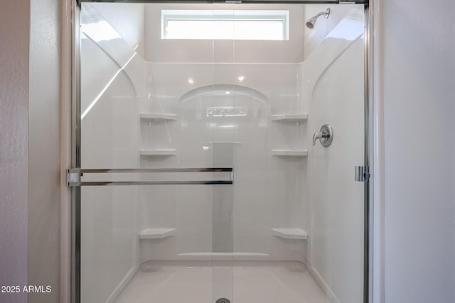 bathroom with a shower with shower door