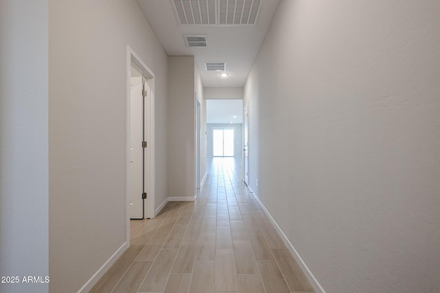 hallway with light hardwood / wood-style flooring