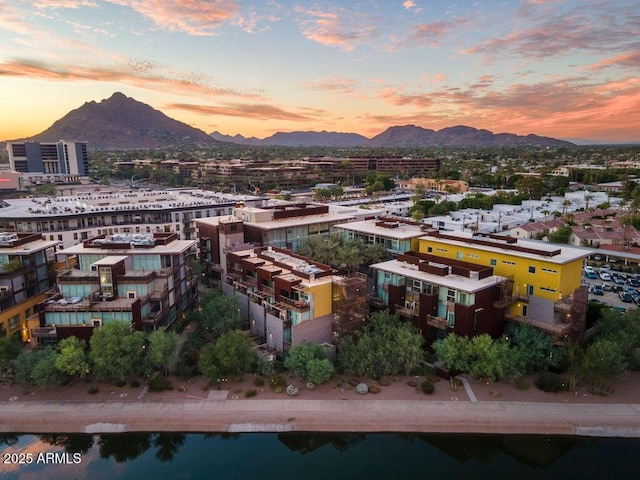 aerial view at dusk featuring a mountain view