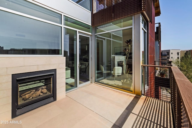 balcony featuring exterior fireplace