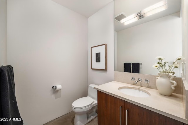 half bathroom with toilet and vanity