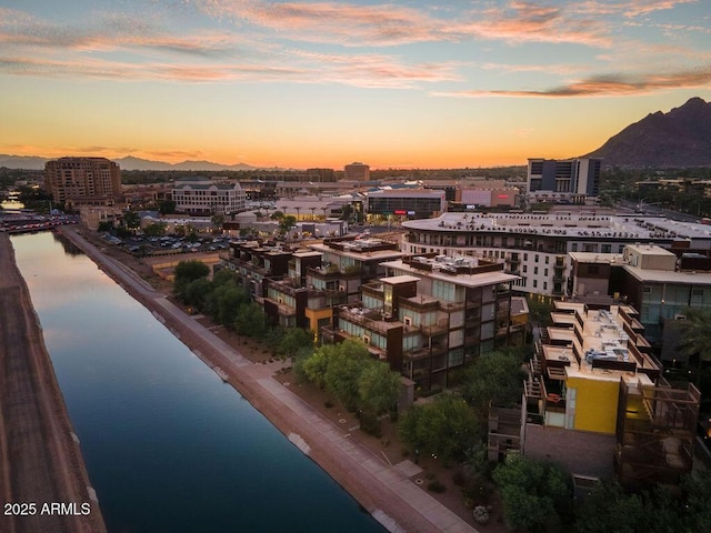 drone / aerial view with a view of city and a water and mountain view