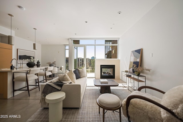 living room featuring a city view, a multi sided fireplace, concrete flooring, and expansive windows