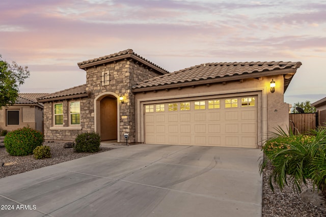 mediterranean / spanish-style home with a garage