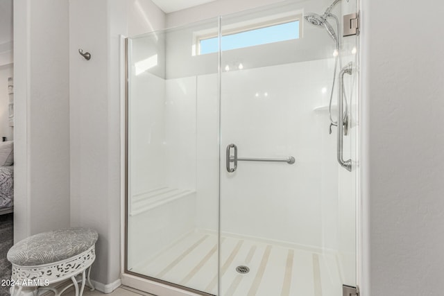 bathroom featuring a shower with door