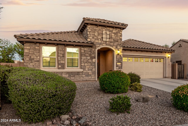 mediterranean / spanish-style home featuring a garage