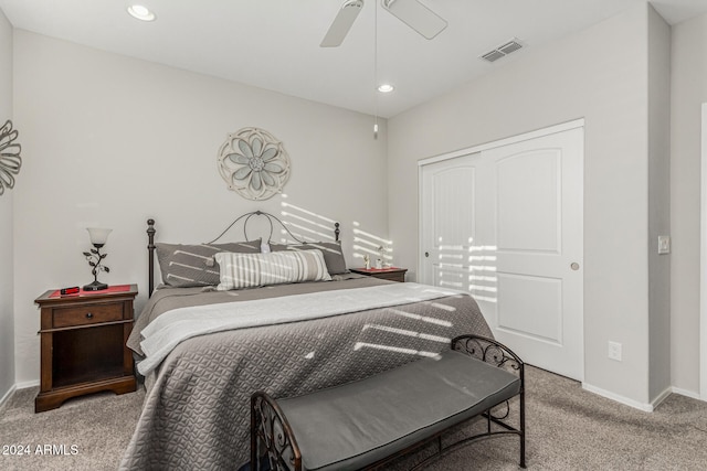 bedroom with a closet, light colored carpet, and ceiling fan