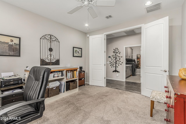 office area featuring light carpet and ceiling fan