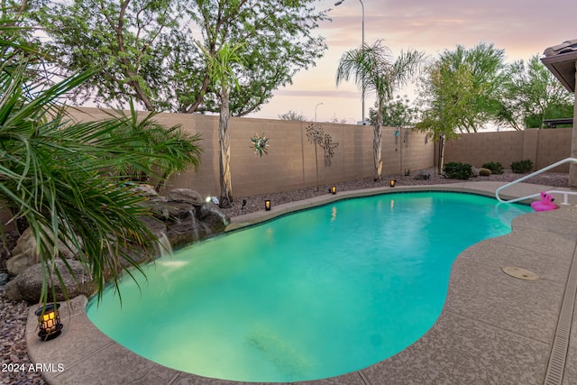 view of pool at dusk