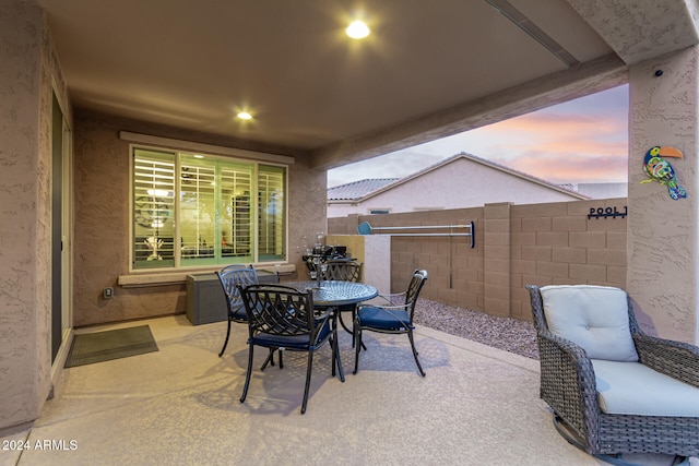 view of patio terrace at dusk