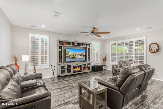 living room with hardwood / wood-style floors and ceiling fan