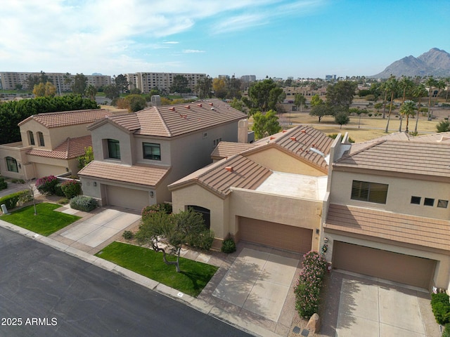 view of front of home with a mountain view and a garage