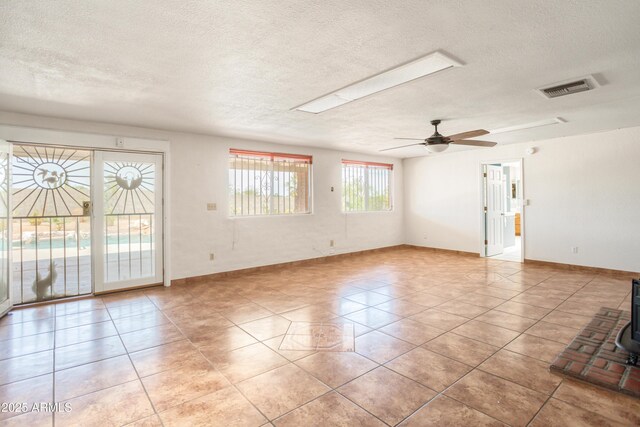 2001 Golf Links Rd, Sierra Vista, AZ 85635 - spare room featuring a textured ceiling, light tile patterned flooring, baseboards, and a ceiling fan