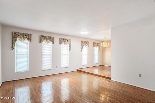 2001 Golf Links Rd, Sierra Vista, AZ 85635 - unfurnished room with a chandelier, wood-type flooring, and baseboards