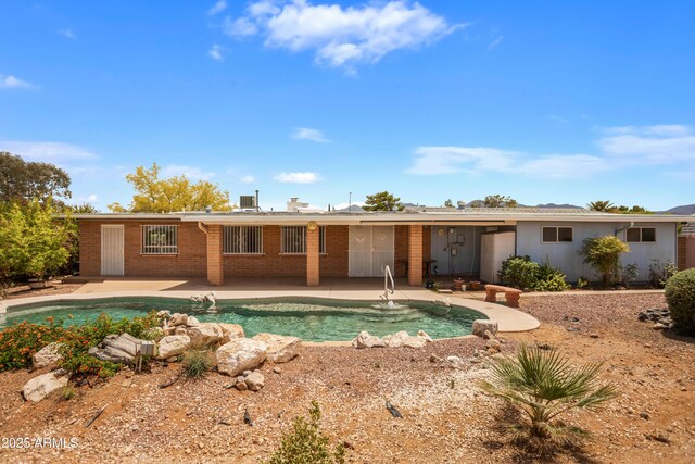 2001 Golf Links Rd, Sierra Vista, AZ 85635 - rear view of property with a patio, brick siding, and an outdoor pool