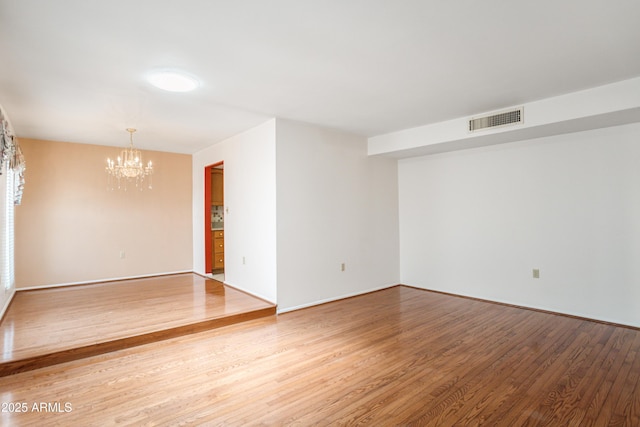 2001 Golf Links Rd, Sierra Vista, AZ 85635 - unfurnished room with a chandelier, wood finished floors, and baseboards