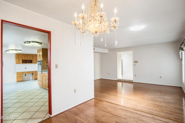 2001 Golf Links Rd, Sierra Vista, AZ 85635 - unfurnished room with a chandelier and light wood-style flooring