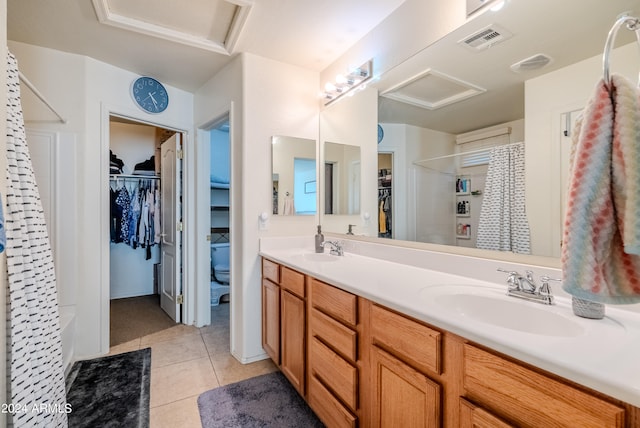 bathroom with vanity, tile patterned flooring, and toilet