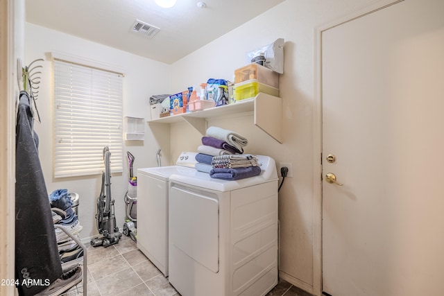 laundry area featuring light tile patterned flooring and separate washer and dryer