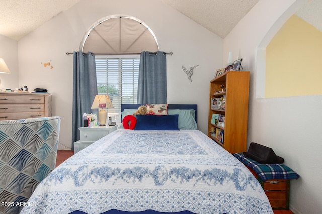 bedroom with vaulted ceiling and a textured ceiling