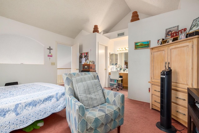 carpeted bedroom with vaulted ceiling and a textured ceiling