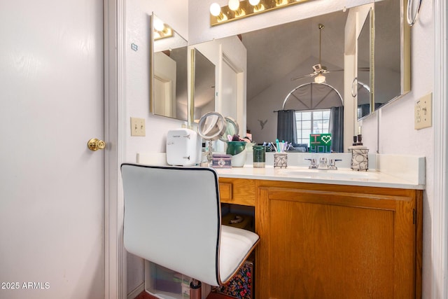 bathroom featuring ceiling fan, vanity, and vaulted ceiling