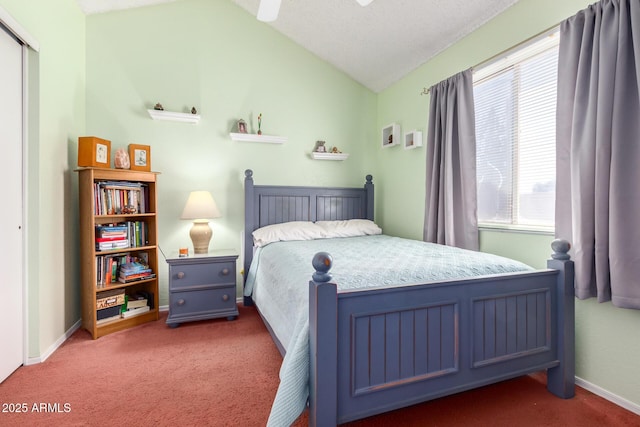 carpeted bedroom featuring vaulted ceiling and a textured ceiling