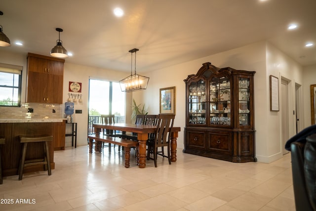 dining area with an inviting chandelier, plenty of natural light, and recessed lighting