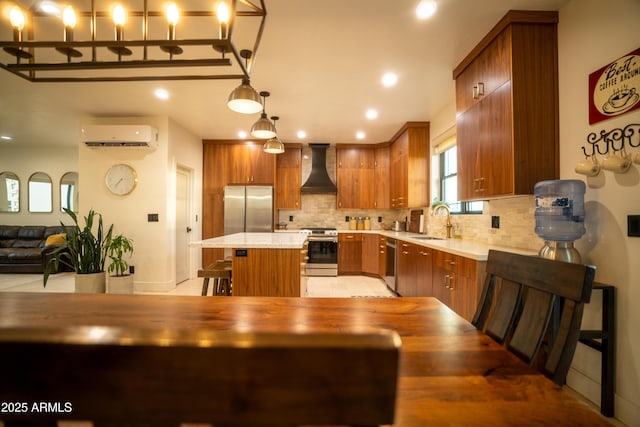 kitchen with premium range hood, a sink, light countertops, a wall mounted air conditioner, and appliances with stainless steel finishes