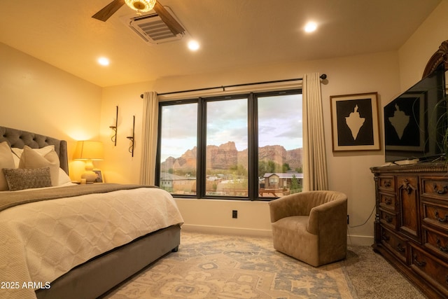 carpeted bedroom with visible vents and baseboards