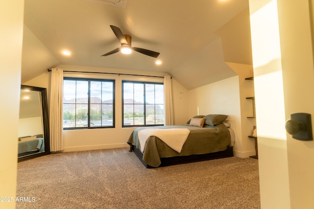 carpeted bedroom with baseboards, lofted ceiling, and a ceiling fan