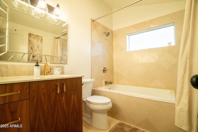 full bathroom featuring tiled shower / bath, toilet, and vanity