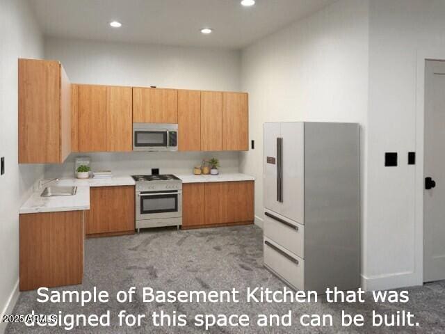 kitchen with recessed lighting, appliances with stainless steel finishes, light countertops, and a sink