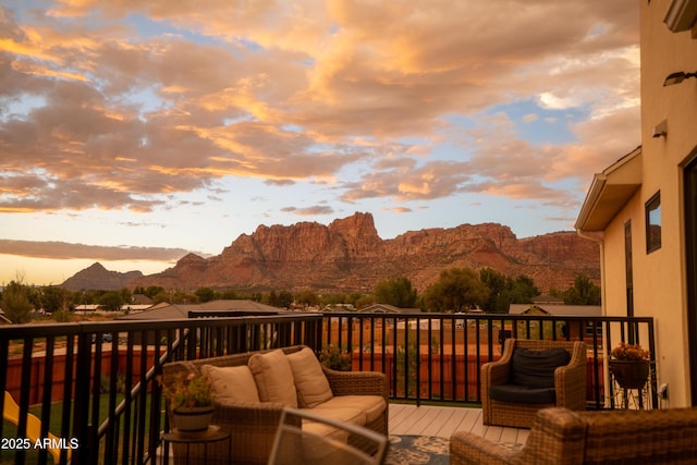 deck at dusk with a mountain view and an outdoor hangout area