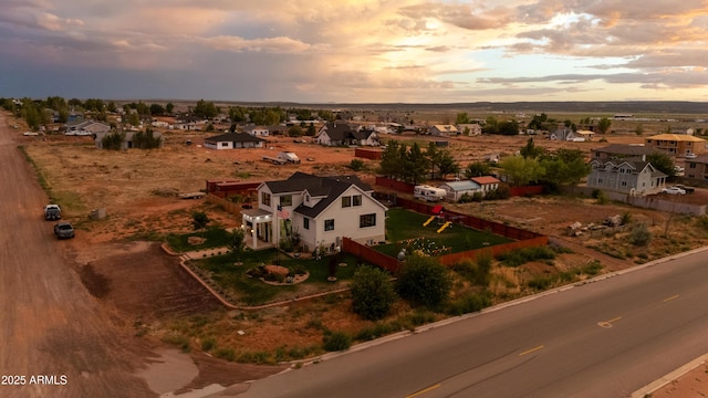 aerial view at dusk featuring a residential view