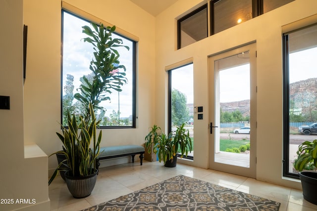 doorway to outside with tile patterned floors