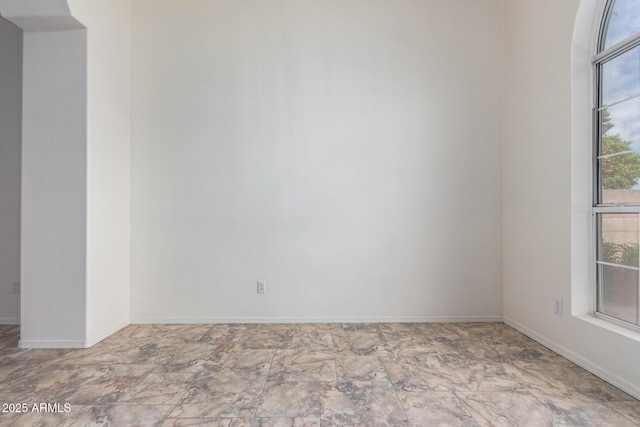 empty room featuring baseboards