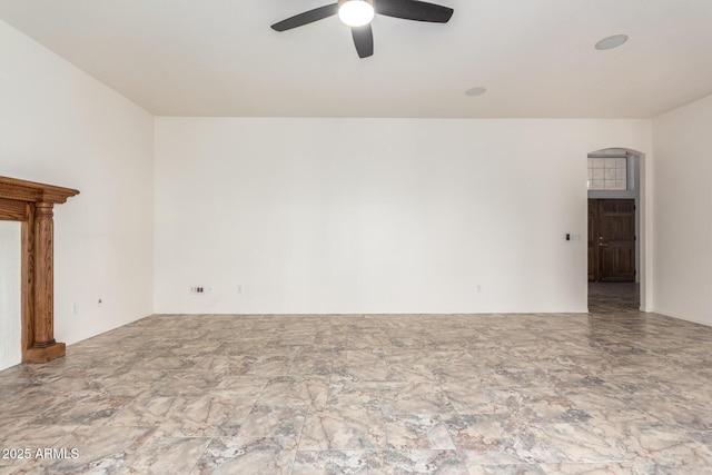 unfurnished living room featuring a ceiling fan