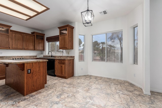 kitchen featuring visible vents, black appliances, glass insert cabinets, decorative light fixtures, and a chandelier