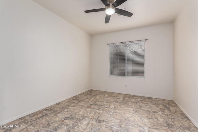 spare room with baseboards and ceiling fan