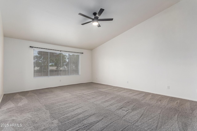 carpeted empty room with baseboards, a ceiling fan, and vaulted ceiling